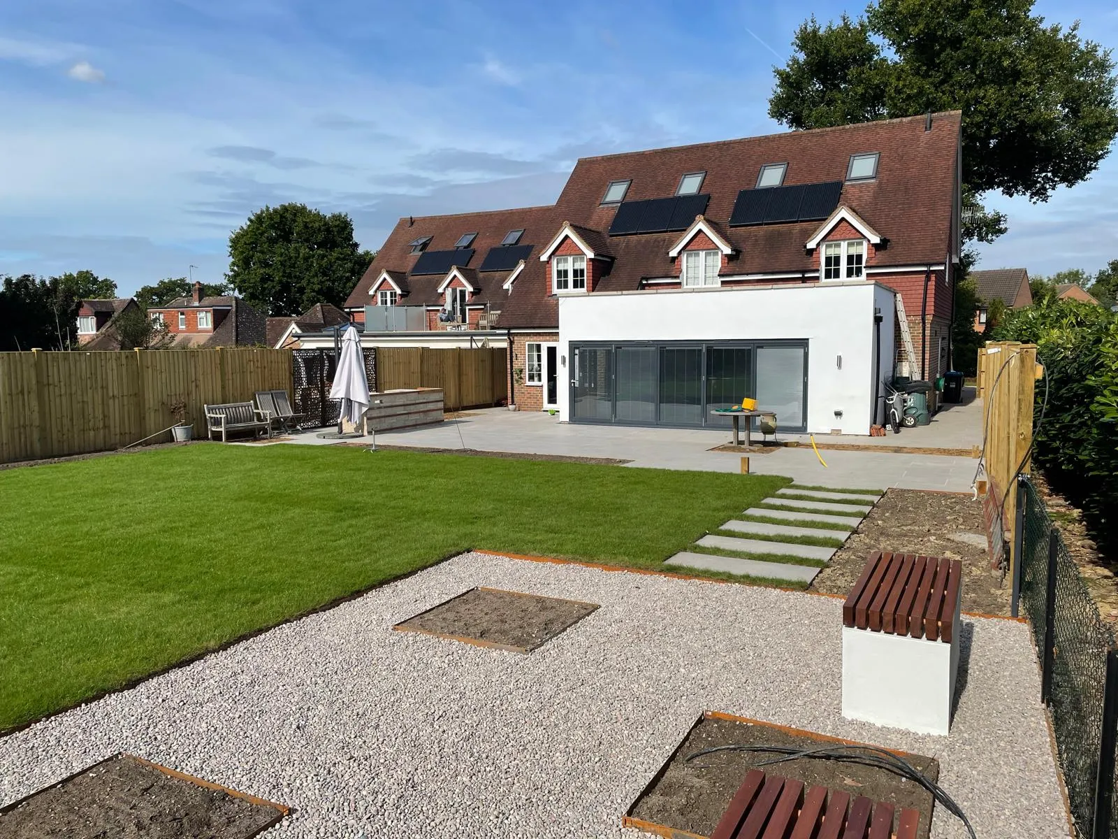 A house with a large lawn and a wooden fence.