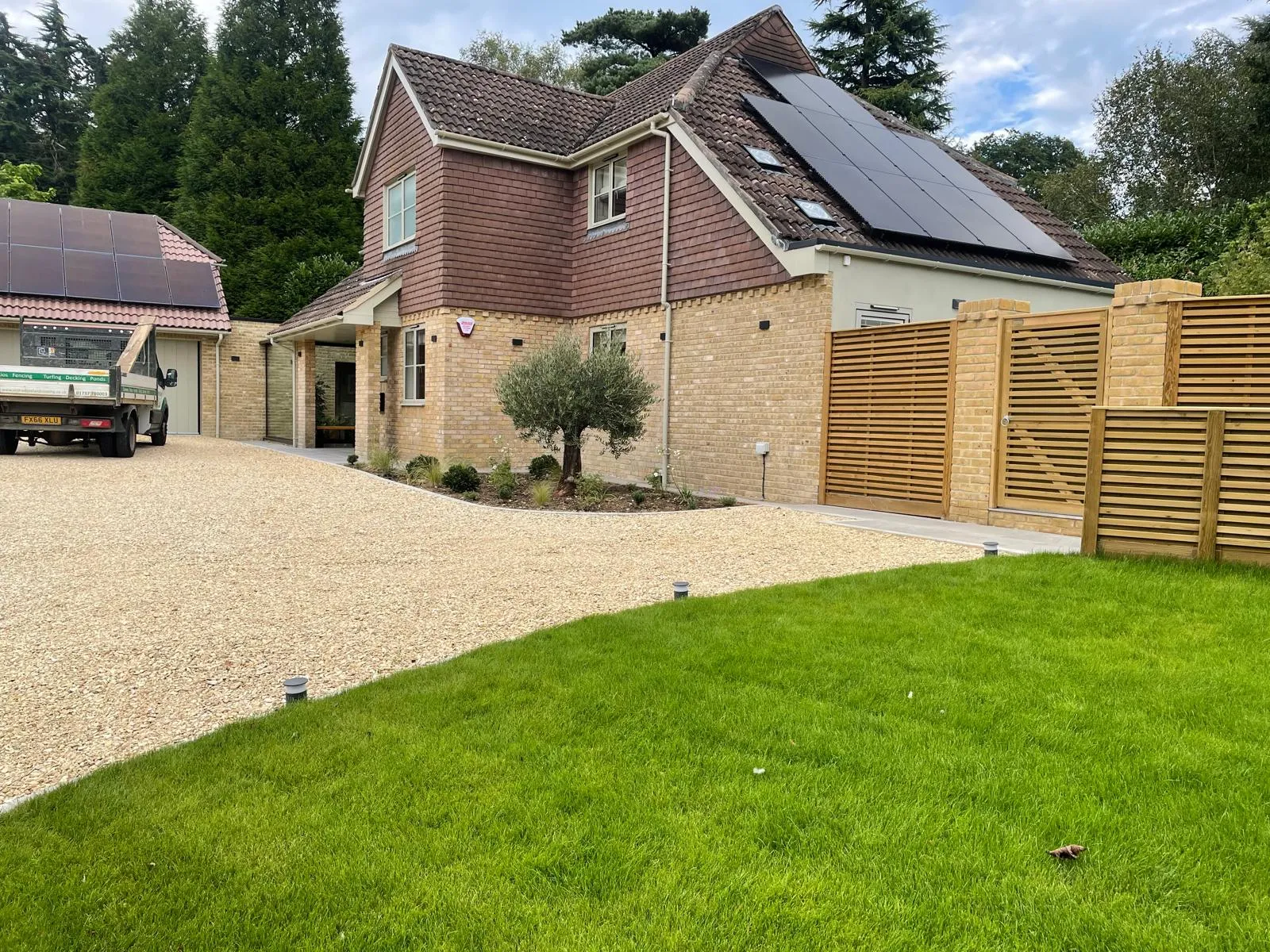 A house with a solar panel on the roof.