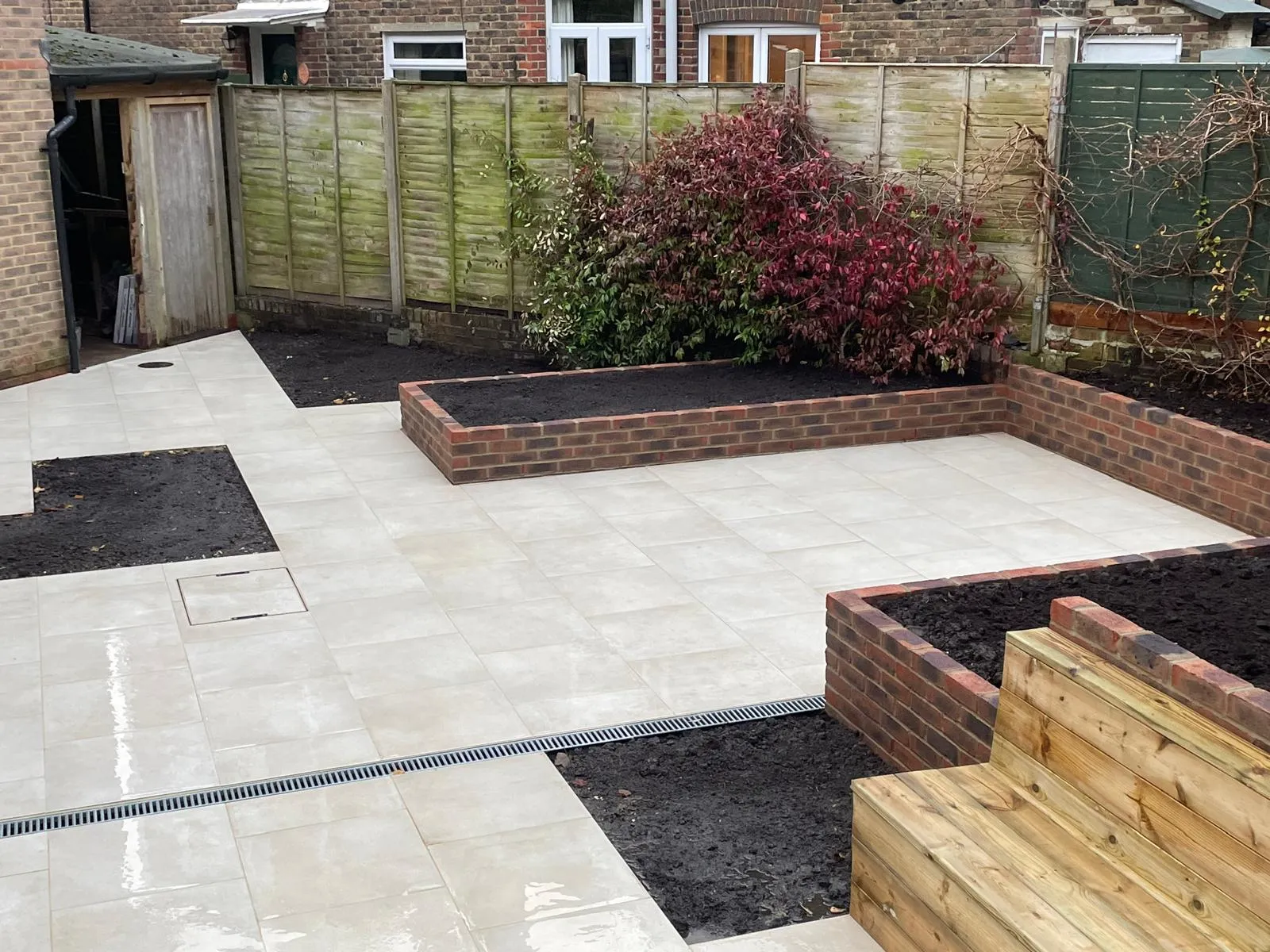 A back yard with a raised garden bed.