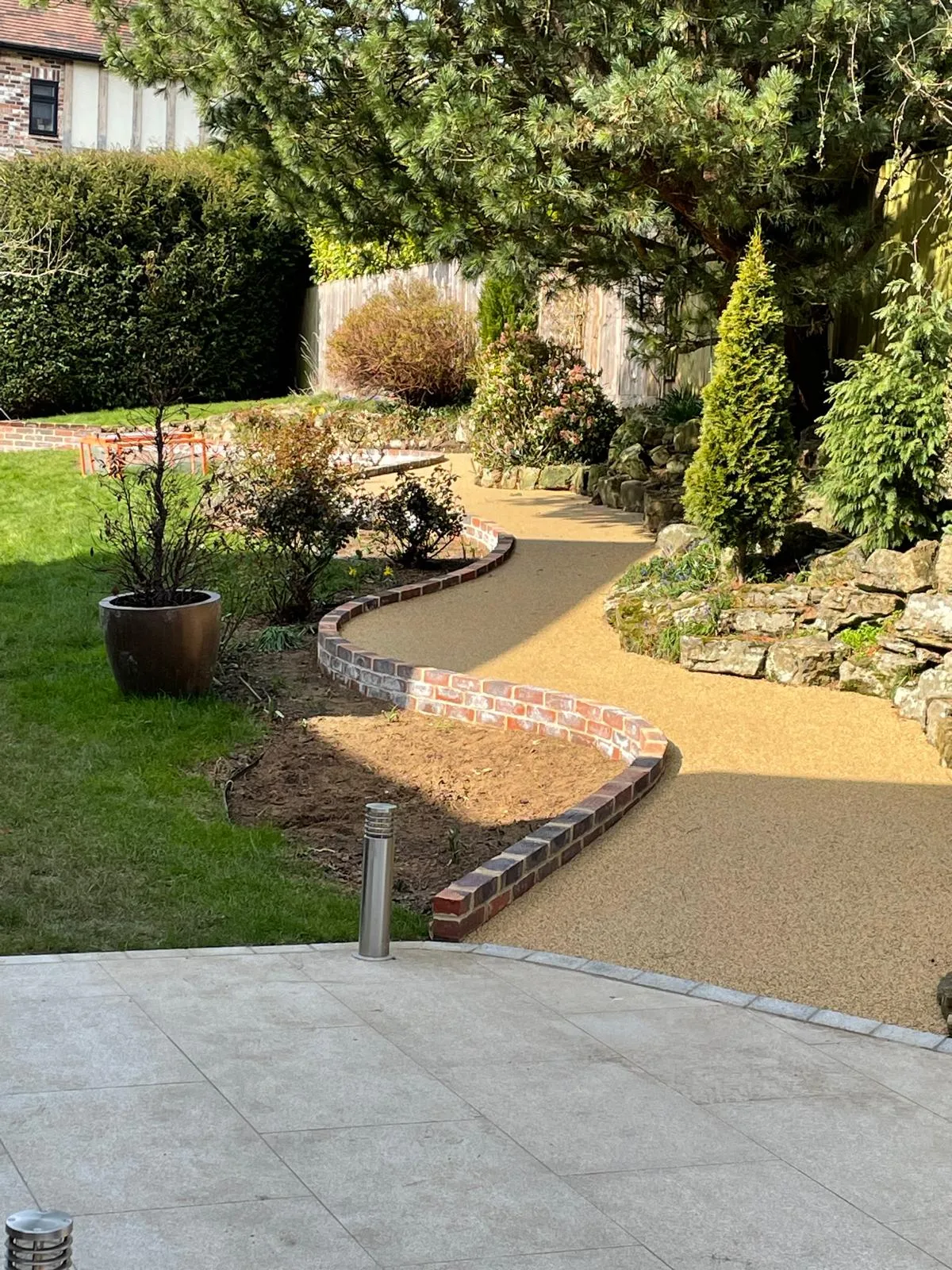 A garden area with a walkway and landscaping.