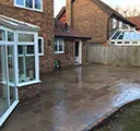 a patio and conservatory at the back of a house